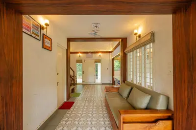 a hallway with a couch in a house at River Wild holiday home in Athirappilly
