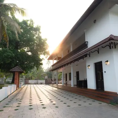 a building with a walkway in front of it at Tamarind Heritage Holiday Home in Angamali