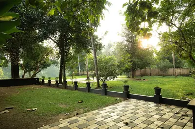 a park with a fence and a walkway at Theeram Riverside Holiday Home in Māla