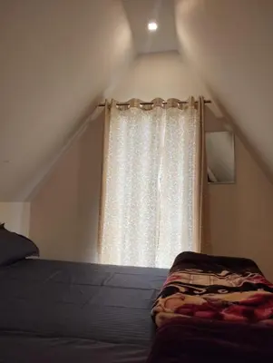 a bedroom with a bed and a window at Hazy Mount Vattavada in Kottakamboor