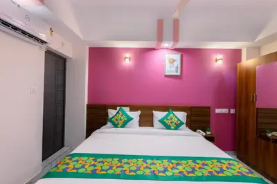 a bedroom with a large bed with a purple wall at Treebo Airsuite Airport Hotel in Cochin