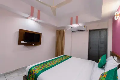 a bedroom with a bed and a tv on the wall at Treebo Airsuite Airport Hotel in Cochin