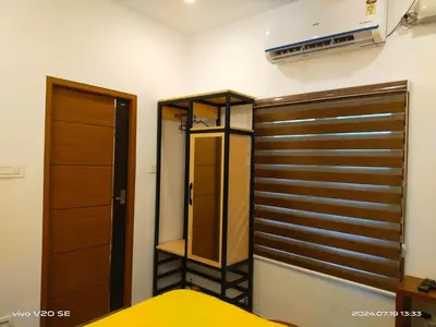 a bedroom with a closet and a bed in it at Merlys Fruit Garden in Cochin