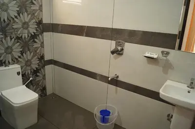 a bathroom with a toilet and a sink at Vihaara Wayanad Serviced Villa in Ambalavayal