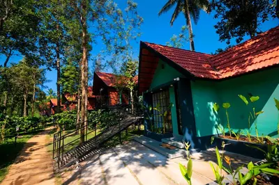 a green house with a red roof at Bay View Suites, Vythiri, Wayanad in Wayanad