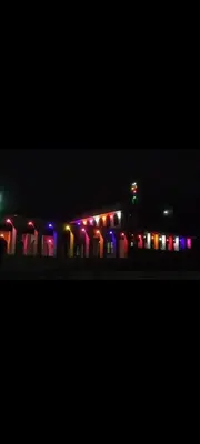 a train station with colorful lights at night at JK Home stay in Sultan Bathery