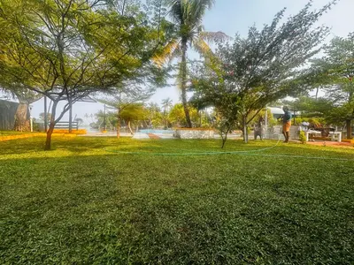a person is flying a kite in a park at CASA DE CANOLI - A Private backwater villa in Kodungallūr