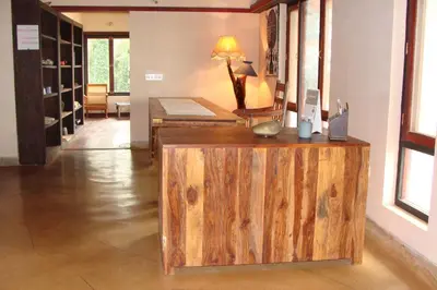 a room with a wooden counter and a room with wine racks at O'Land Wilderness Lodge in Kolakambe