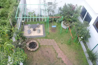 an aerial view of a garden with a table and plants at Misty Meadows in Kodaikānāl