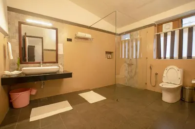 a bathroom with a sink and a toilet and a shower at Sinna Dorai's Rotti Kadai Bungalow in Vālpārai