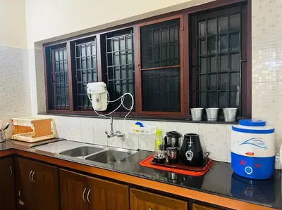 a kitchen with a sink and a counter top at Meadows Serene Retreat in Kannur