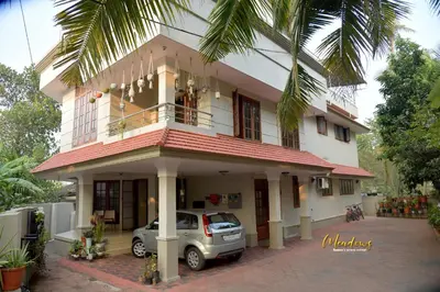 a car parked in front of a house at Meadows Serene Retreat in Kannur