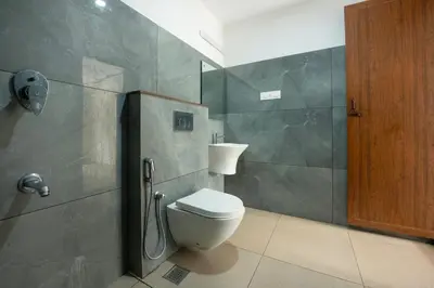 a bathroom with a toilet and a shower stall at Span Avenue in Kozhikode