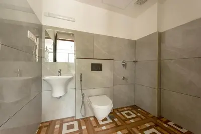 a bathroom with a toilet and a sink at Span Avenue in Kozhikode
