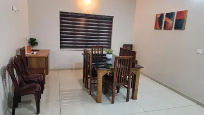 a dining room with a table and chairs at Nambiaparambil Serviced Villa in Kakkayam