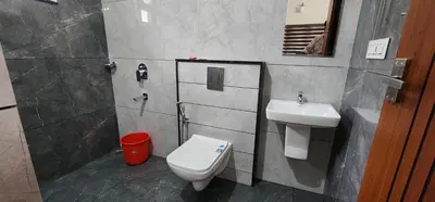 a bathroom with a toilet and a sink at Nambiaparambil Serviced Villa in Kakkayam