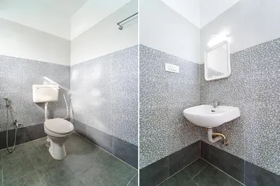 a bathroom with a toilet and a sink at Via Bala Garden in Ooty