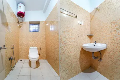 a bathroom with a toilet and a sink at Via Bala Garden in Ooty