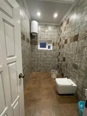 a bathroom with a toilet and a sink at The Misty Valley in Kodanād