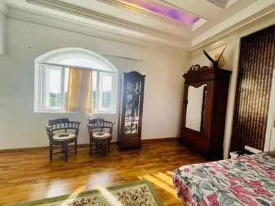 a bedroom with a bed and a table and chairs at The Misty Valley in Kodanād