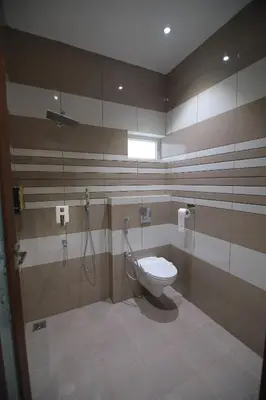 a bathroom with a toilet and a shower at PitStop21 in Athirappilly