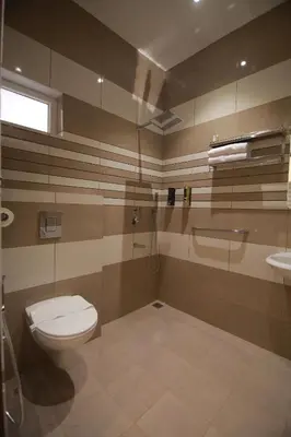a bathroom with a toilet and a sink at PitStop21 in Athirappilly
