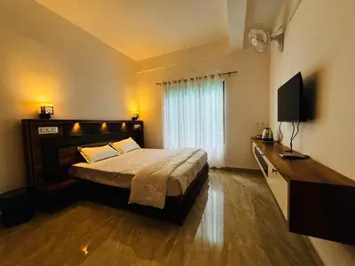a bedroom with a bed and a television in it at casa wayn homestay in Sultan Bathery