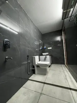 a bathroom with a toilet and a shower and a sink at casa wayn homestay in Sultan Bathery