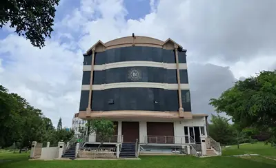 a building with a tower on top of it at Bimba Hotels in Mysore