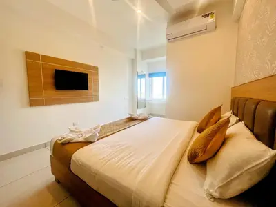a bedroom with a large bed in a room at Bimba Hotels in Mysore