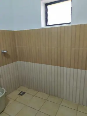 a bathroom with a shower stall with a window at Tropical Blooms by StayApart in Kutta