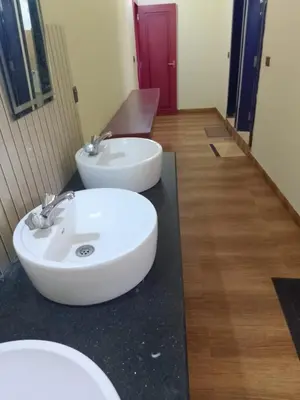 a bathroom with a white sink on a counter at Tropical Blooms by StayApart in Kutta