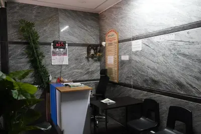 a room with a counter and a table and chairs at Golden Bells in Vānivilāsa Puram