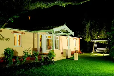 a small house with a gazebo in a yard at Bella Vista Homestay in Coonoor