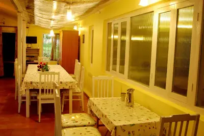 a dining room with two tables and chairs in a room at Bella Vista Homestay in Coonoor