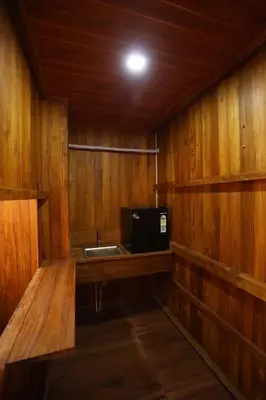 a kitchen with a sink and a microwave at Karingens Resort in Malayāttūr