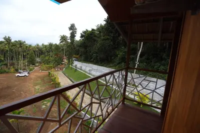 a view from the balcony of a house at Karingens Resort in Malayāttūr