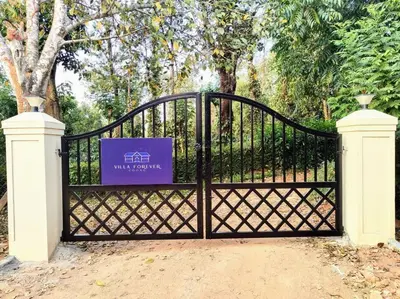 a black gate with a purple sign on it at Villa Forever Coorg in Madikeri