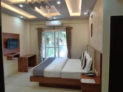 a bedroom with a large bed and a television at Dkgardenia24 in Kanakapura
