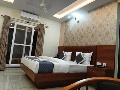 a bedroom with a large bed and a window at Dkgardenia24 in Kanakapura