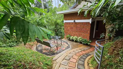 a brick house with a bench in front of it at Casta Wild Resort in Batheri