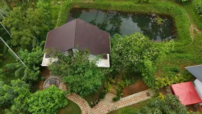 an overhead view of a house with trees and a pond at Casta Wild Resort in Batheri