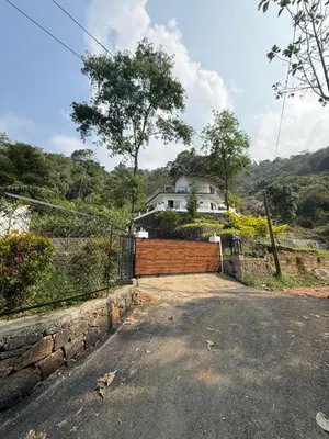 a house on a hill with a fence at Brooke hills falls view in Vallikavungal