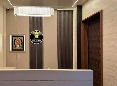 a lobby with a sign on the wall next to a door at Hotel BR Grand in Coimbatore