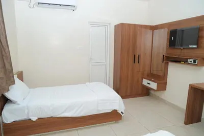 a bedroom with a bed and a tv on a wall at Hotel BR Grand in Coimbatore