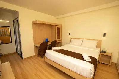 a hotel room with a large bed and a desk at Lazo Silver Lake , Ooty in Ooty