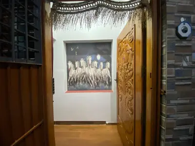 a doorway into a room with a painting on the wall at Jk homestay Mysore in Mysore