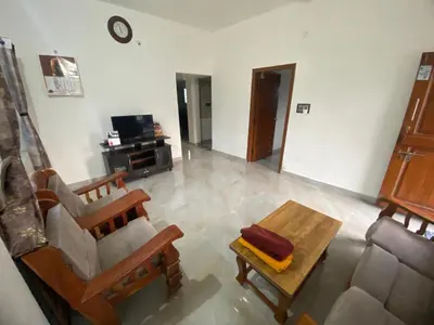 a living room with a couch and a table at Jk homestay Mysore in Mysore
