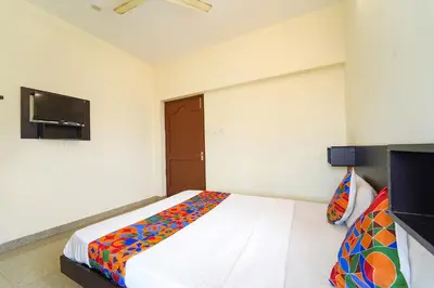 a bedroom with a bed and a flat screen tv at Via Aarudra s Residency in Coimbatore