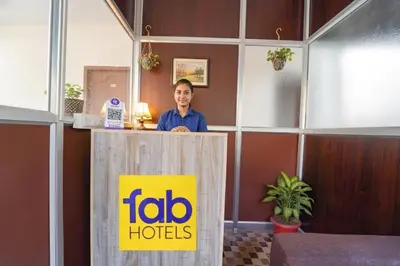 a man standing behind a podium with aida hotels sign at Via Aarudra s Residency in Coimbatore